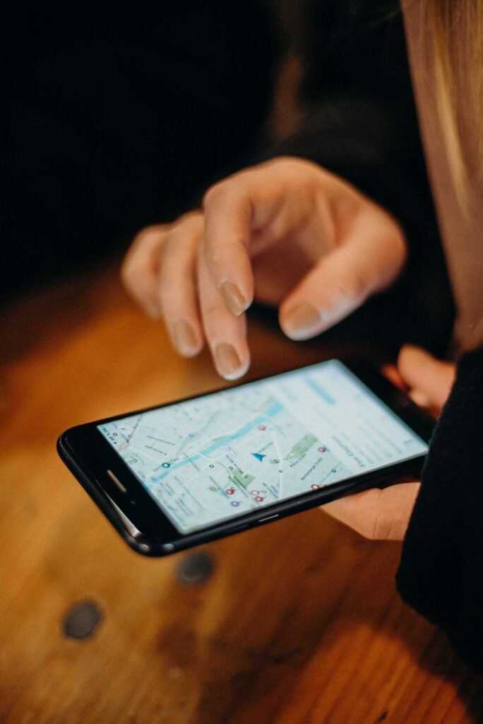 Smartphone displaying google maps ranking retail singapore search results near a shopfront