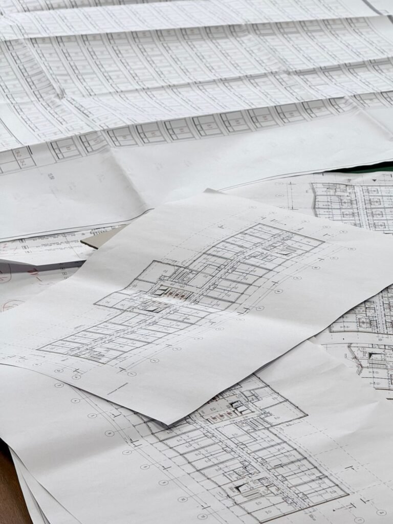 Detailed architectural blueprints on a desk representing the seo blueprint construction singapore firms can follow