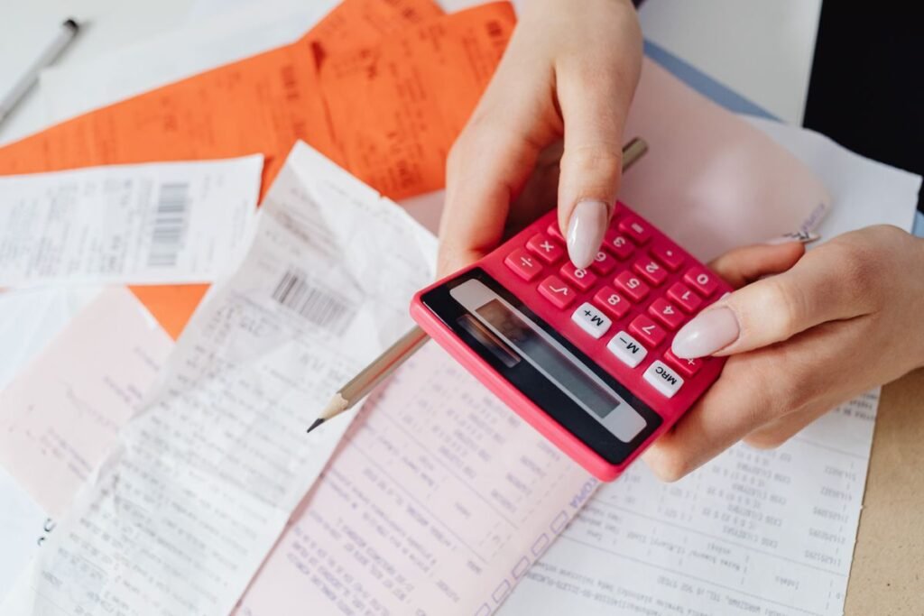 Person using a calculator to budget for seo cost construction singapore firms should expect