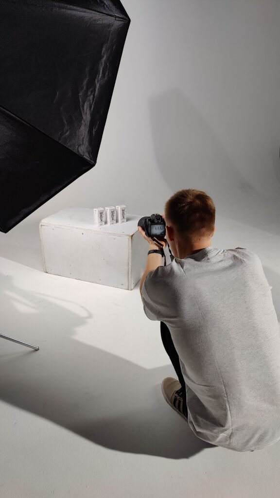 Photographer in a studio capturing product shots for Shopify image SEO Singapore optimisation
