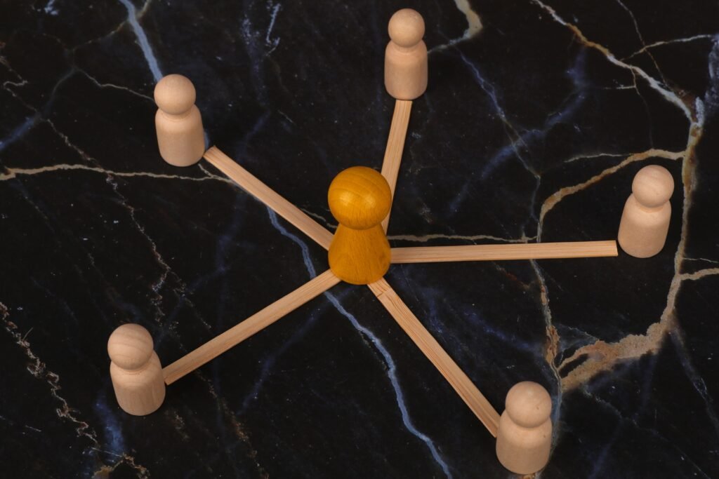 Wooden figures connected in a network concept representing Shopify link building Singapore strategy