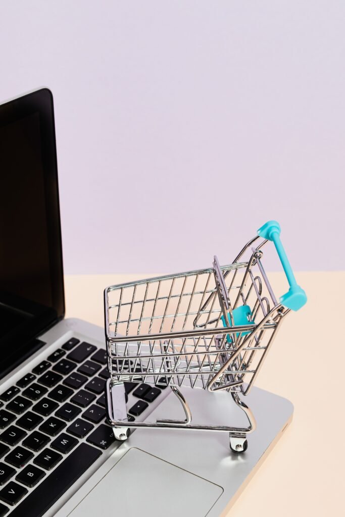 Shopify vs WooCommerce SEO Singapore comparison shown with a shopping cart icon on a laptop screen