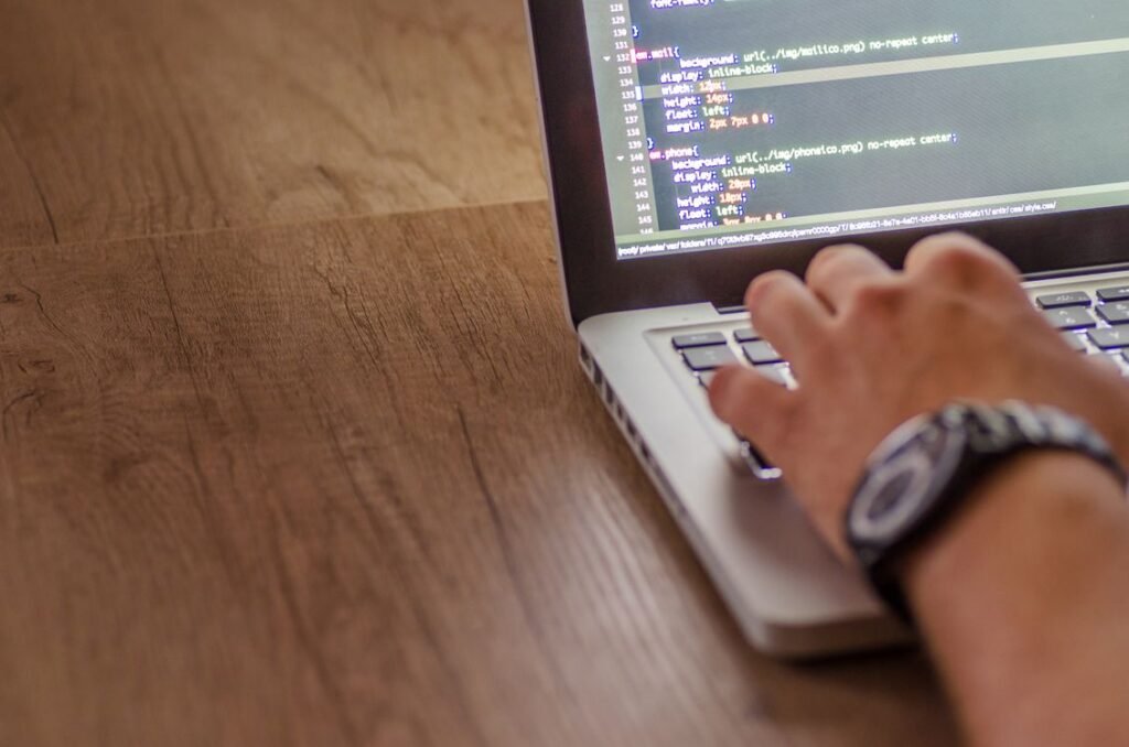 Singapore web developer editing a WordPress robots.txt Singapore configuration file on a laptop in a home office setting.