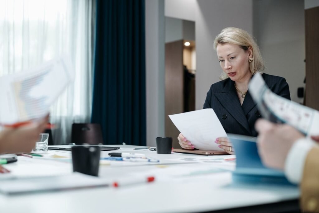 Business owner evaluating an ai based seo proposal with line items circled during an agency meeting