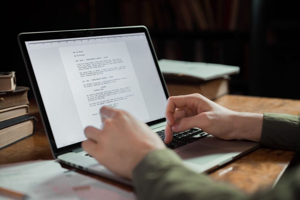 A writer editing a draft article on a laptop, illustrating how to write a guest blog post an editor will accept