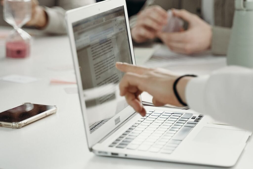 A marketer reviewing printed documents beside a laptop while running an off page seo audit