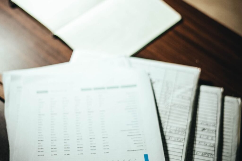 Five printed workstreams spread across a desk showing the full scope of off page seo services