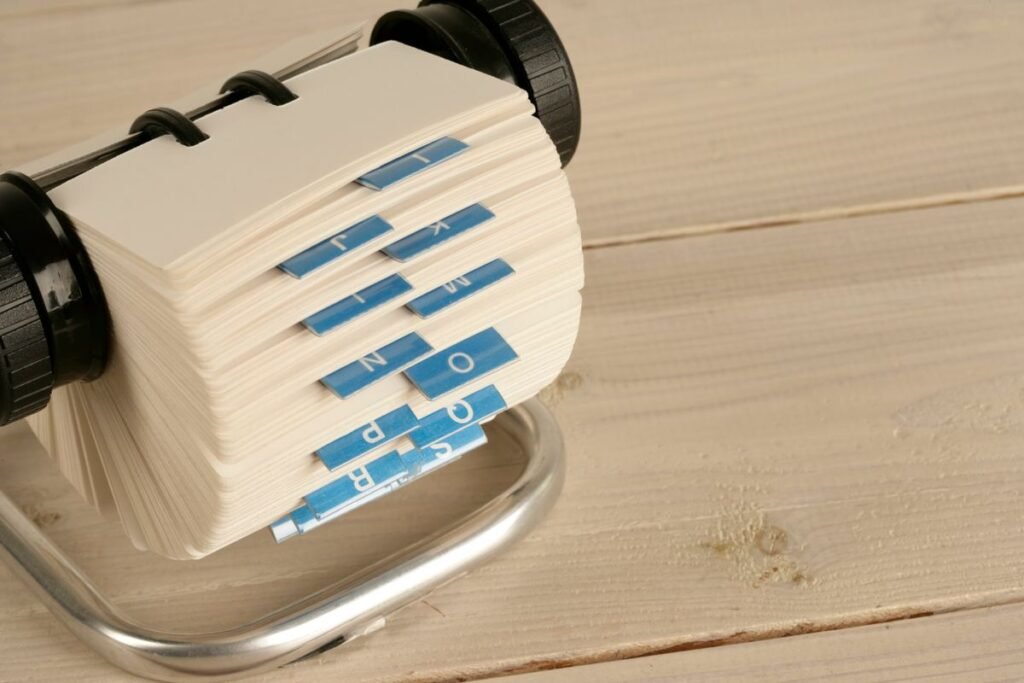 Rolodex of business contacts representing a curated list of backlink sites for a Singapore business
