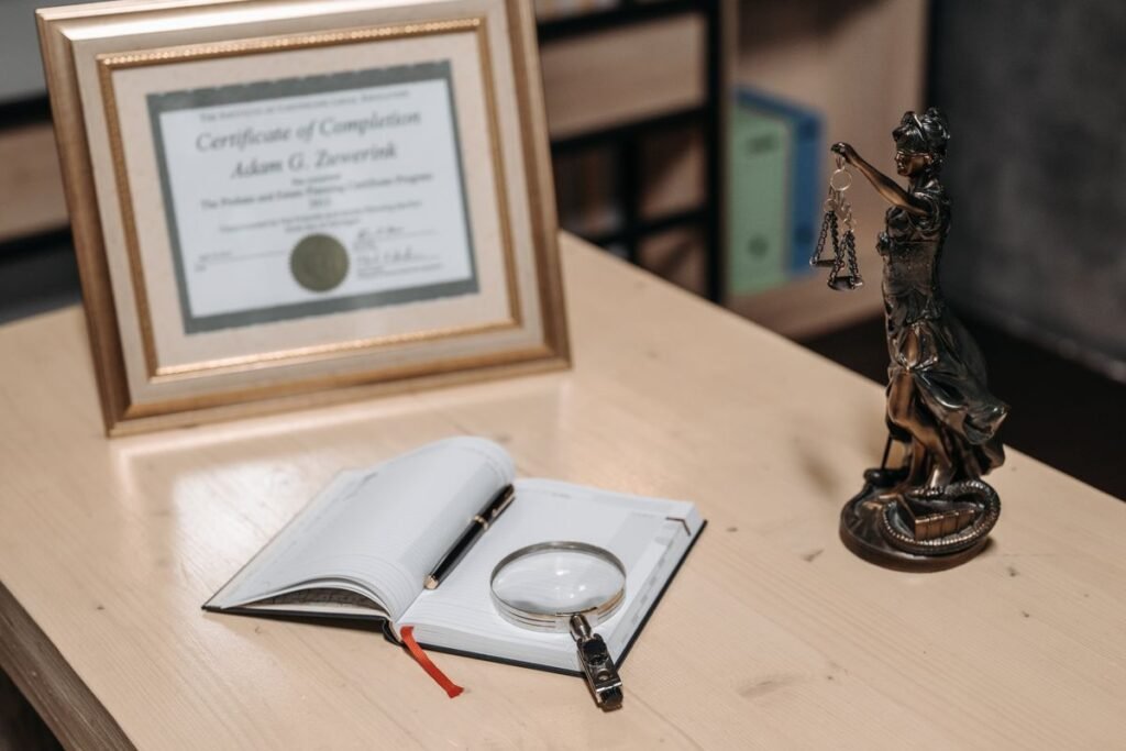 Framed certificate on an office desk beside a notebook, representing a google analytics certification
