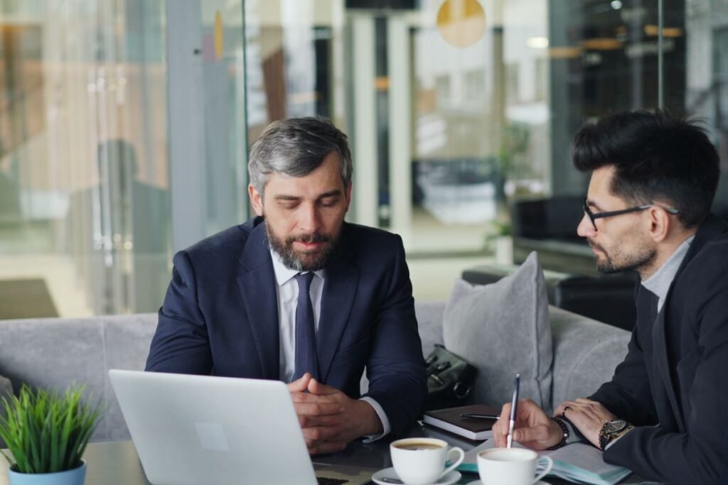 Consultant and client reviewing a laptop together while scoping google analytics consulting services