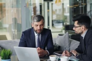 Consultant and client reviewing a laptop together while scoping google analytics consulting services