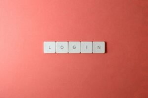 Letter tiles spelling LOGIN on a pink background, representing Google Search Console login and access