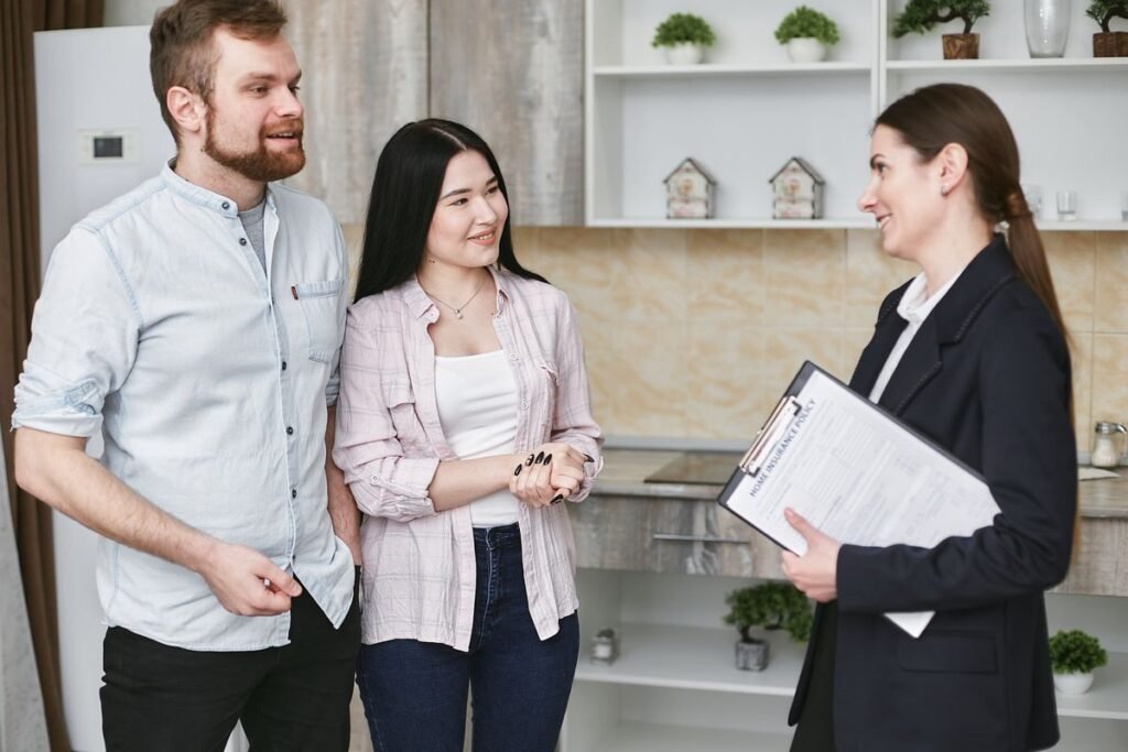Couple talking with an insurance representative at home, illustrating insurance marketing built on trust