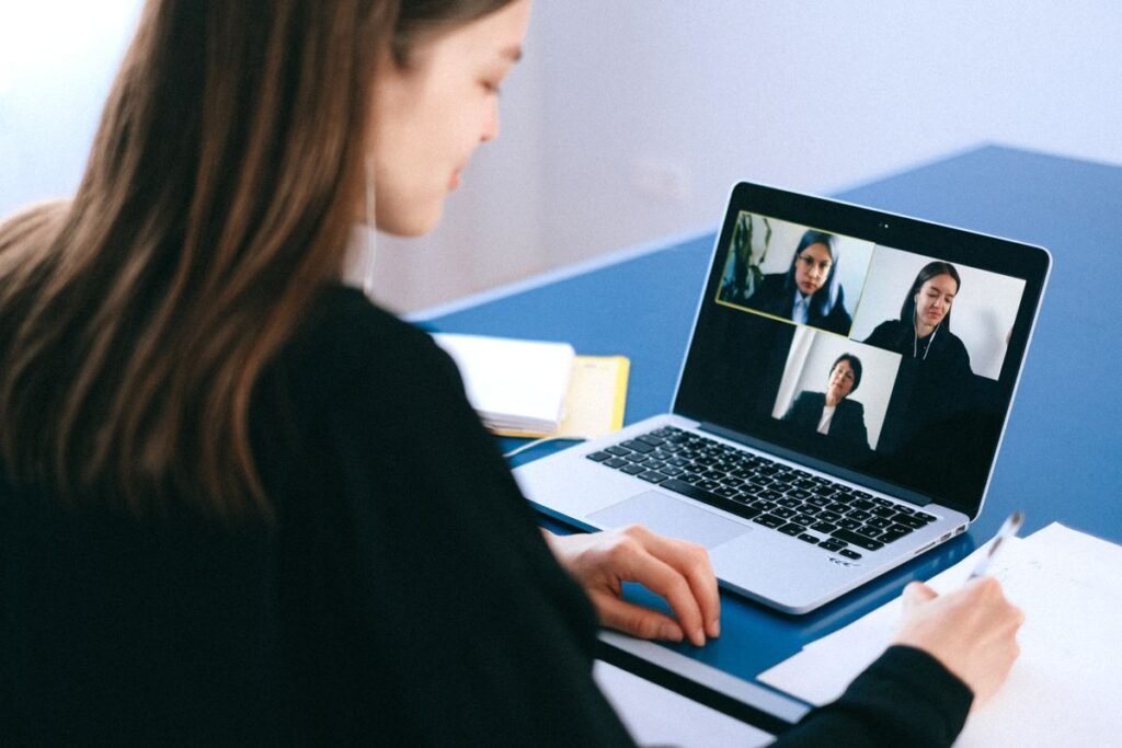 Woman on a video call with a remote team, representing outsource SEO services in Singapore