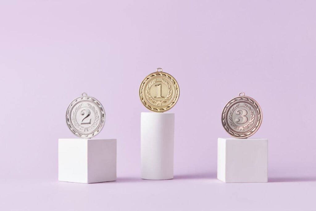 Gold, silver and bronze medals on podiums, representing positions reported by a rank tracking tool