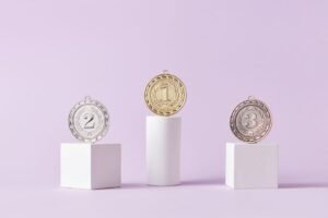 Gold, silver and bronze medals on podiums, representing positions reported by a rank tracking tool