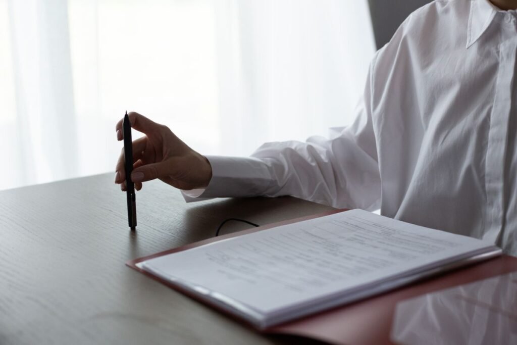 Person reviewing a document with a pen, representing how to read an SEO proposal