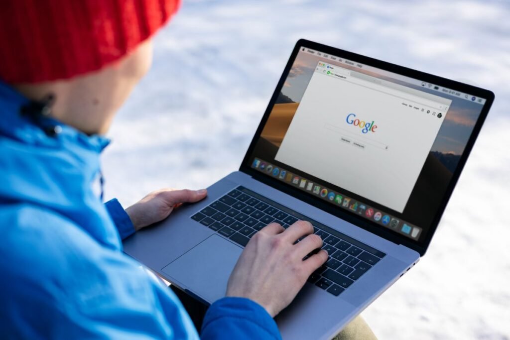 Person searching Google on a laptop, where structured data SEO shapes how listings appear