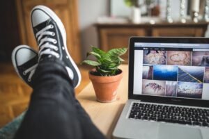 Visitor browsing a website on a laptop at home, the kind of visit behind whats bounce rate