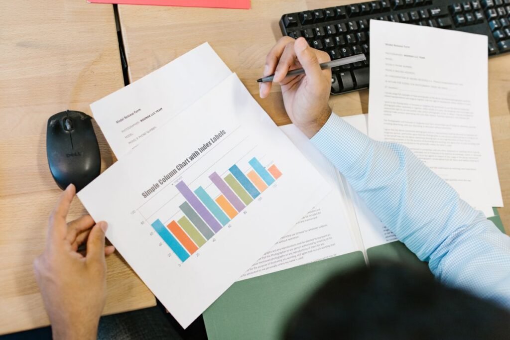 Hands marking up a printed report chart beside a keyboard while reviewing a white label SEO audit