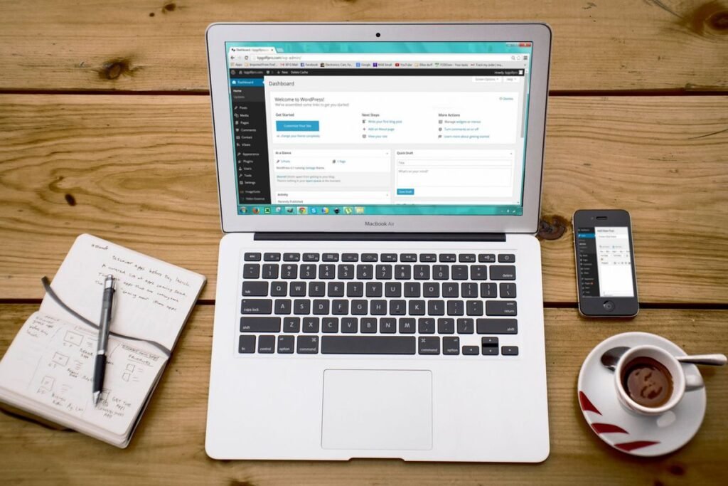 Laptop showing a WordPress dashboard on a wooden desk, ready to configure Yoast SEO structured data